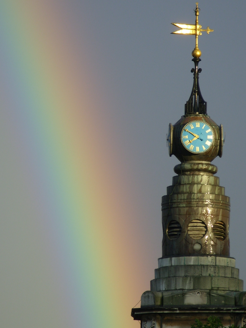 St Anne’s Church tower and clock with a rainbow over Soho — photograph by Sheila Ruskin